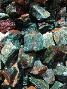 Typical pieces of Green Aventurine rough rock, pictured wet